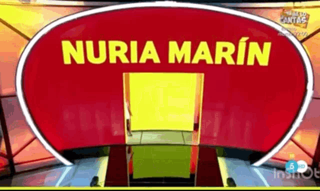 a red sign that says nuria marin in yellow letters