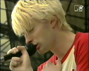 a close up of a person 's face with a mtv logo in the background