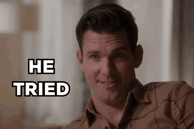 a man in a plaid shirt is smiling with the words he tried behind him