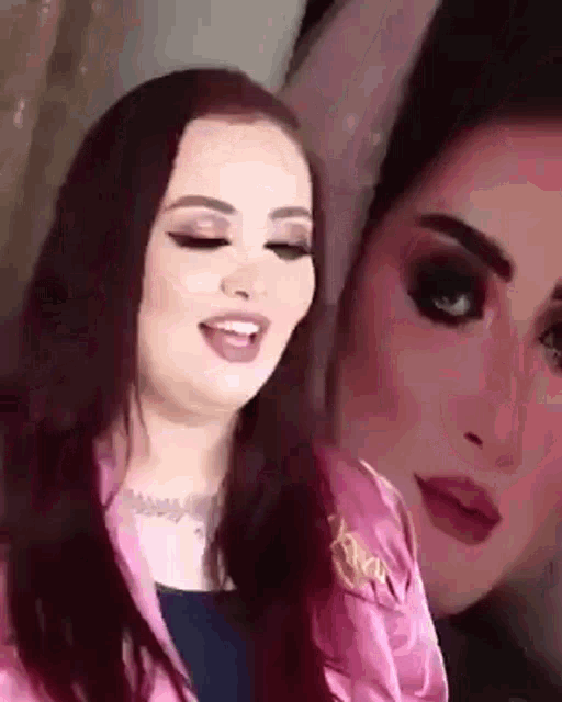 a close up of a woman 's face with a reflection of another woman 's face .