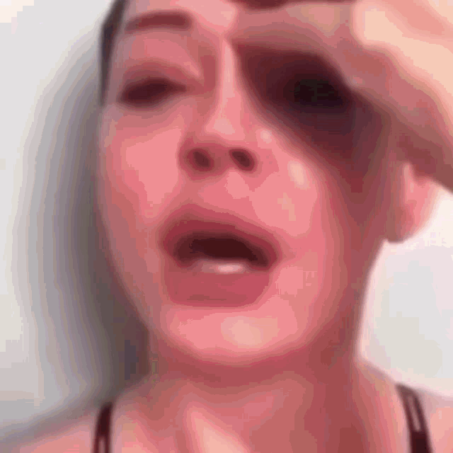 a close up of a woman 's face with her mouth open