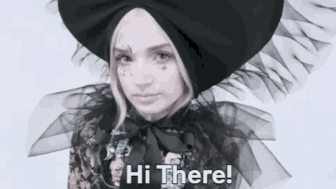 a woman is wearing a black hat and a floral dress and says hi there .