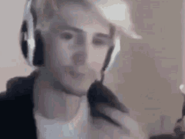 a man is wearing headphones and holding a microphone .