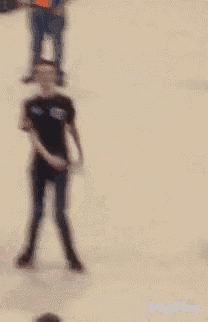 a blurry picture of a person standing in the sand