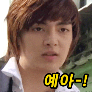 a close up of a young man 's face with a yellow sticker that says e-a-a-a-!