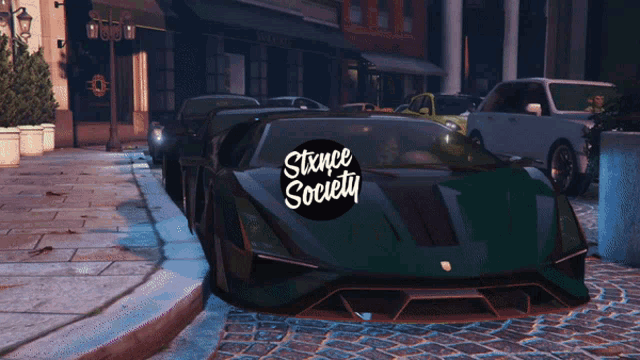 a bunch of cars parked in a parking lot with a sticker that says stance society on it