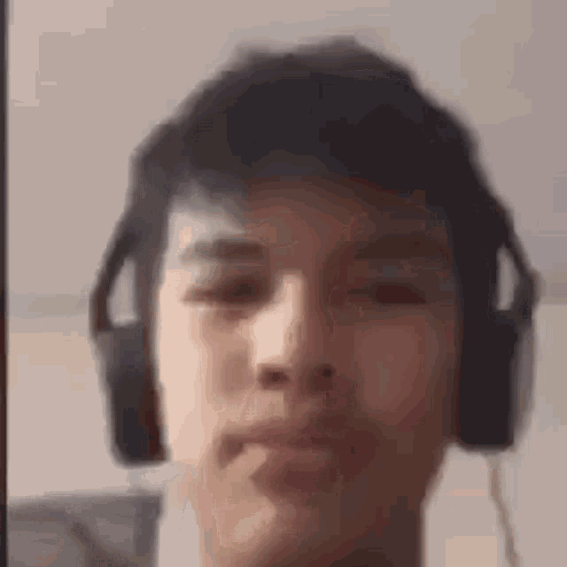 a close up of a man wearing headphones .