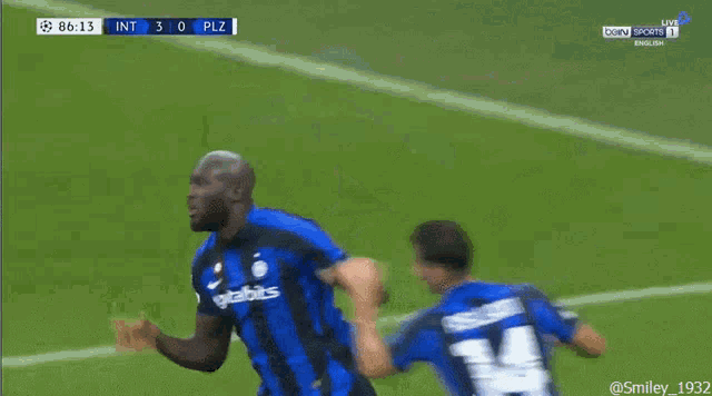 a soccer player with the number 24 on his jersey is being tackled by another player