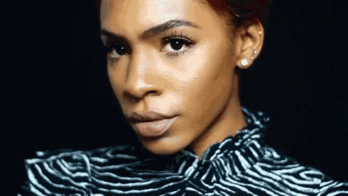 a close up of a woman 's face with a zebra print shirt