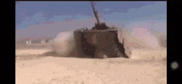 a military vehicle is driving through a desert