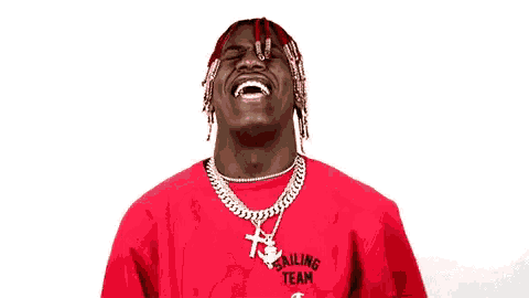 a man with red hair is wearing a red sweater and a gold chain .