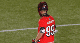 a lacrosse player wearing a red jersey with the number 99