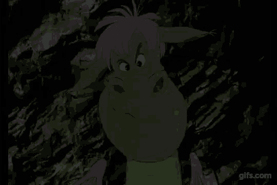 a green cartoon character with pink hair is standing next to a rock .