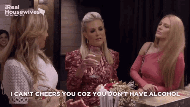 a woman holding a glass of wine says i can t cheers you coz you don t have alcohol