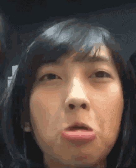 a close up of a woman making a funny face with her tongue sticking out .
