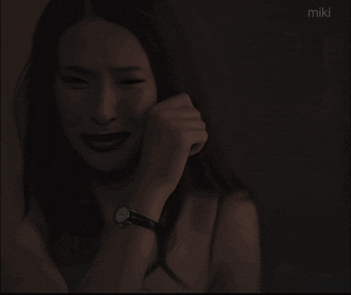 a painting of a woman crying with the word miki on the bottom