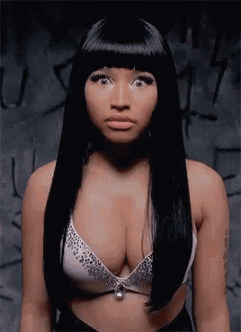a woman with long black hair is wearing a bra with rhinestones