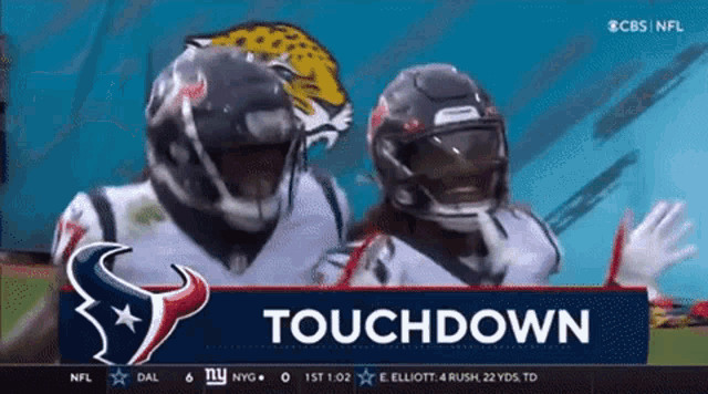 two football players are standing in front of a banner that says touchdown on it