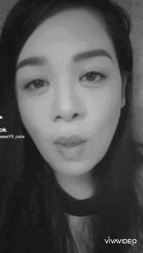 a woman 's face is shown in a black and white photo with the words vivavideo below it