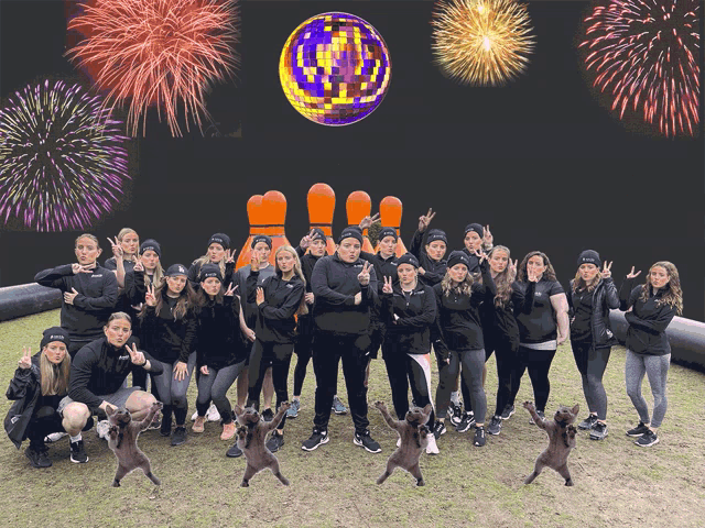 a group of people standing in front of a disco ball with fireworks in the background