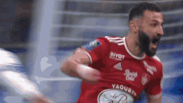 a man with a beard is wearing a red shirt with yaourts on it