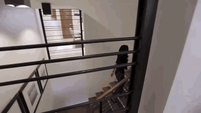 a woman is walking up a set of stairs