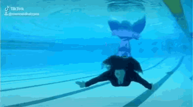 a woman is swimming underwater in a pool with a tiktok watermark on the bottom