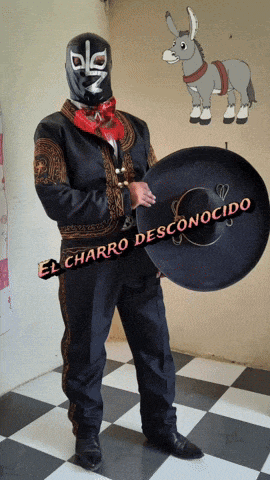 a man in a mariachi costume is holding a sombrero with el charro desconocido written on it