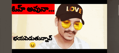 a man wearing sunglasses and a hat that says love on it