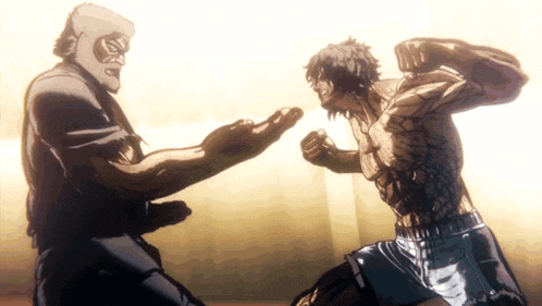 two men are fighting each other in a boxing match .
