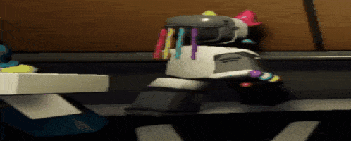 a robot with a ponytail on its head is standing next to a table .
