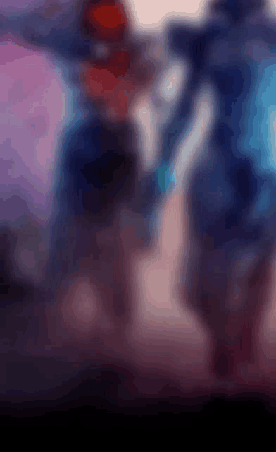 a blurry picture of two people standing next to each other in a room