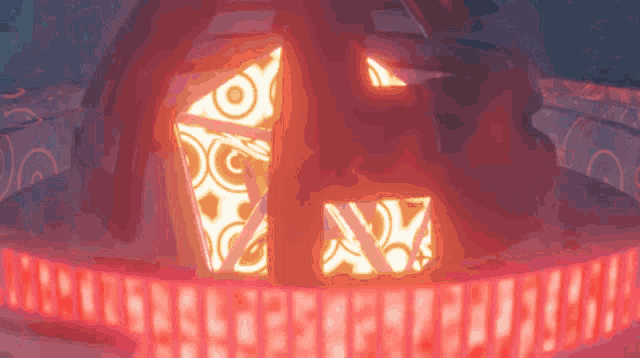 a pumpkin with a face carved into it is surrounded by red lights