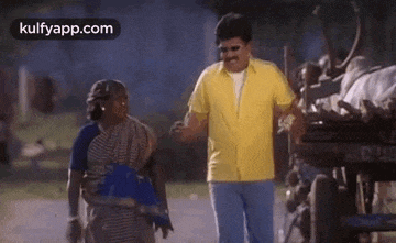 a man in a yellow shirt is talking to a woman in a blue dress .