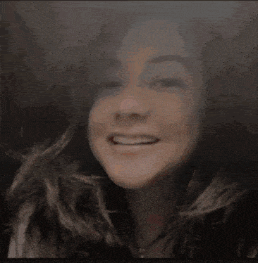 a close up of a woman 's face smiling