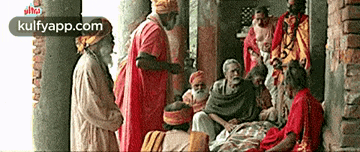 a group of men are standing around a group of people sitting on a porch .