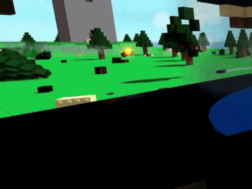 a computer screen shows a video game with trees and blocks