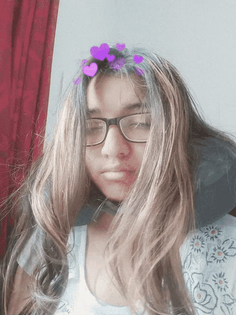 a girl with long hair and glasses has purple hearts in her hair