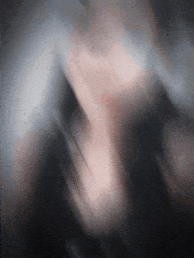 a blurry picture of a person 's face with a gray and white background