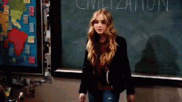 a woman is standing in front of a blackboard that says civilization