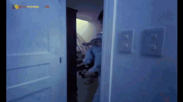 a person is standing in a doorway with a sign that says star movies