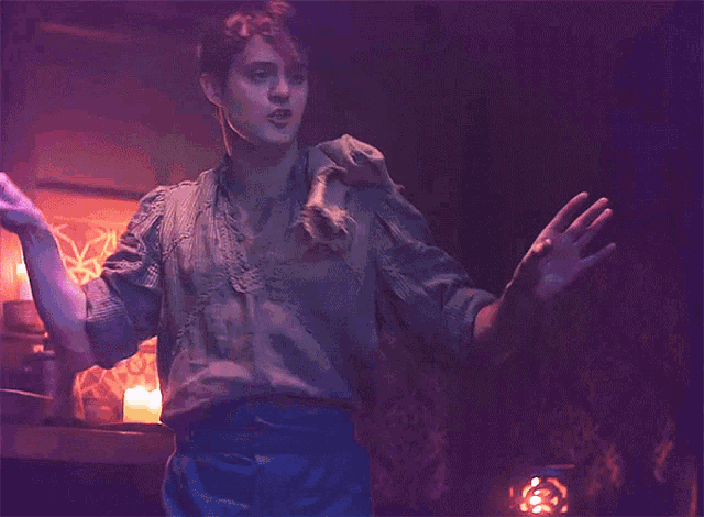 a man is surrounded by pink hearts that are coming out of his hands