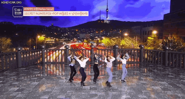 a group of women are dancing on a balcony with the words secret number written on the bottom