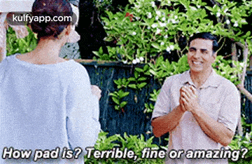 a man and a woman are standing next to each other in a garden and the man is asking the woman how pad is .