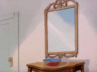 a cartoon cat is looking at himself in the mirror