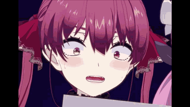 a close up of a girl 's face with a surprised look on her face