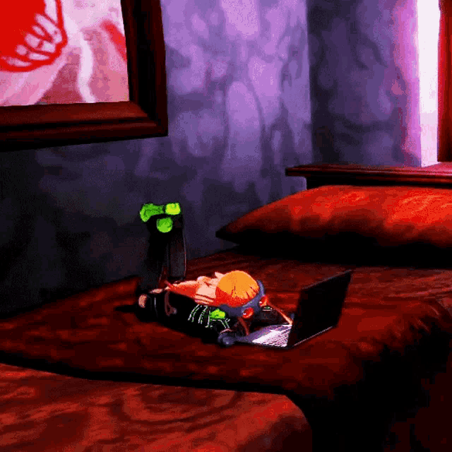 a laptop sits on a bed next to a stuffed toy
