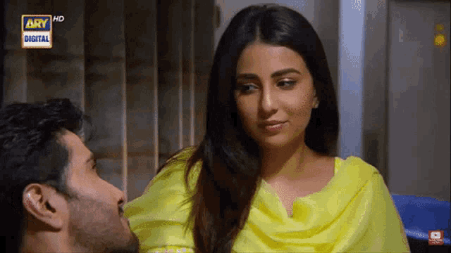 a man kisses a woman on the cheek while watching a tv show called ary digital