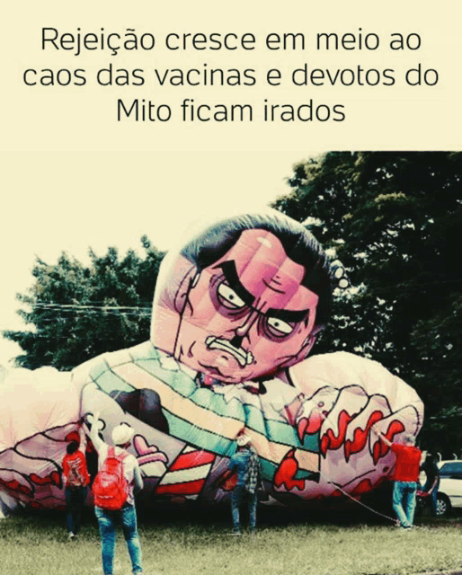 a large inflatable figure of a man with an angry face is being pulled by a rope