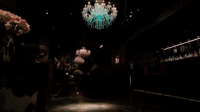 a painting of a clown in a dark room with a chandelier in the background